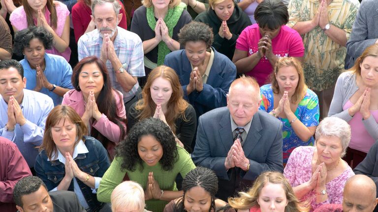 A large group of people praying