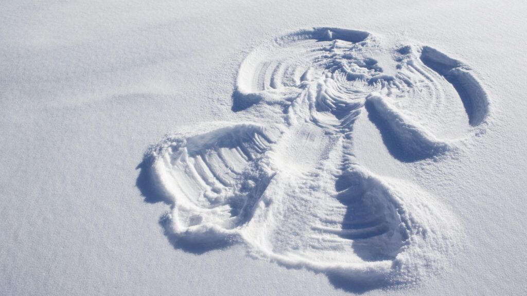 A large, majestic snow angel on a bed of untouched snow.