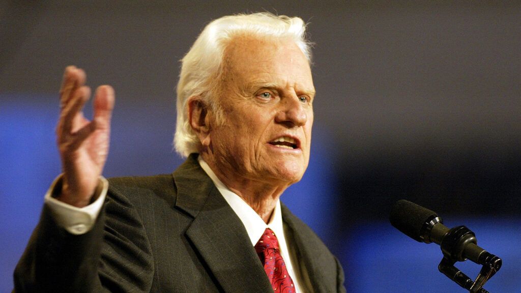 The Reverend Dr. Billy Graham speaks at one of his crusades