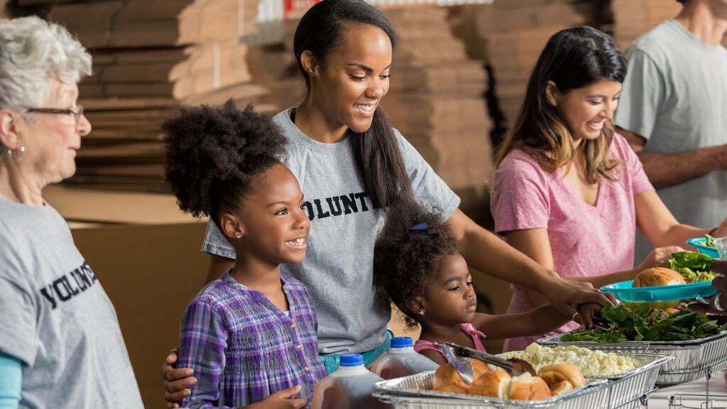 A family volunteers at a food pantry