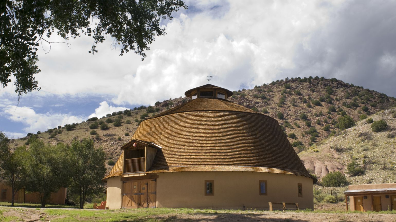 The round barn at Ojo Caliente Mineral Springs was built in 1924. It is the only round barn in New Mexico and possibly the only remaining adobe round barn in the United States. It was added to the National Register of Historic Places in 1985.