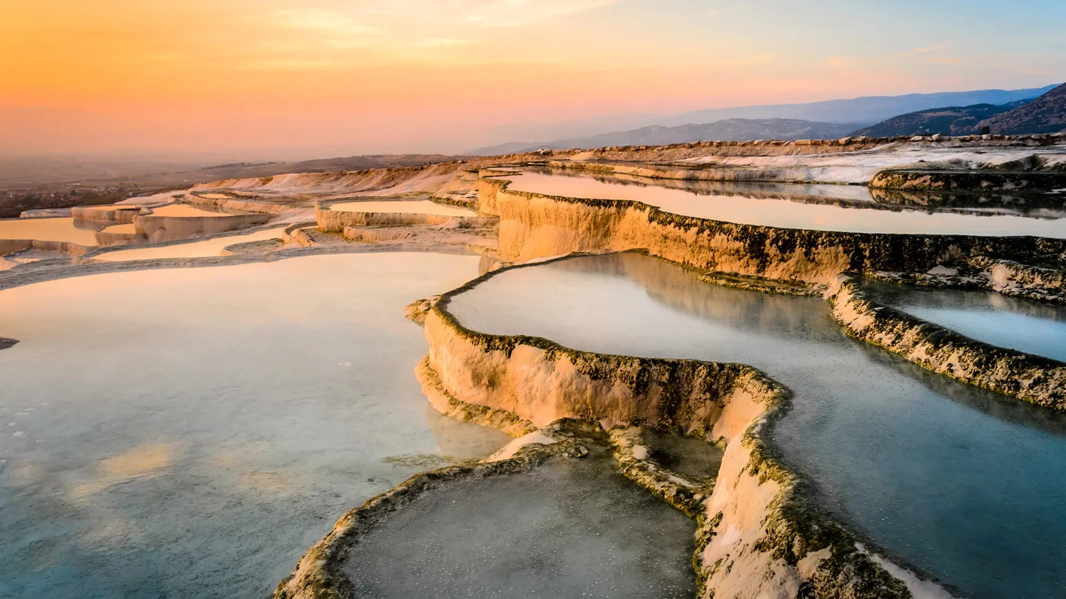 Carbonate travertines the natural pools during sunset, Pamukkale, Turkey