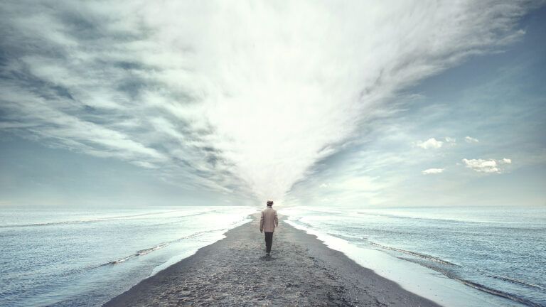 A man walks along the beach