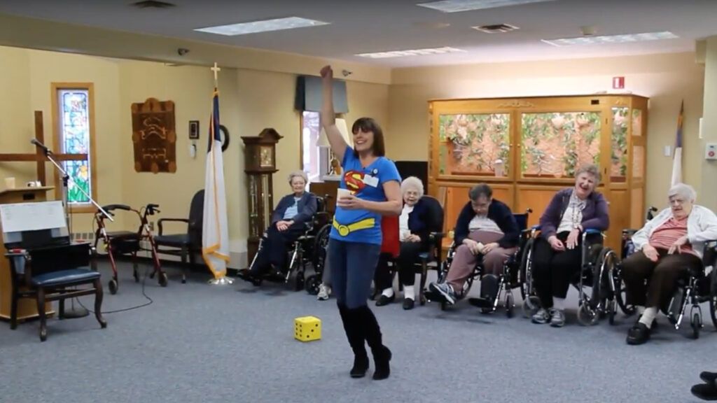 Volunteer Lisa Alden playing a game with the senior citizens of the Good Samaritan Society