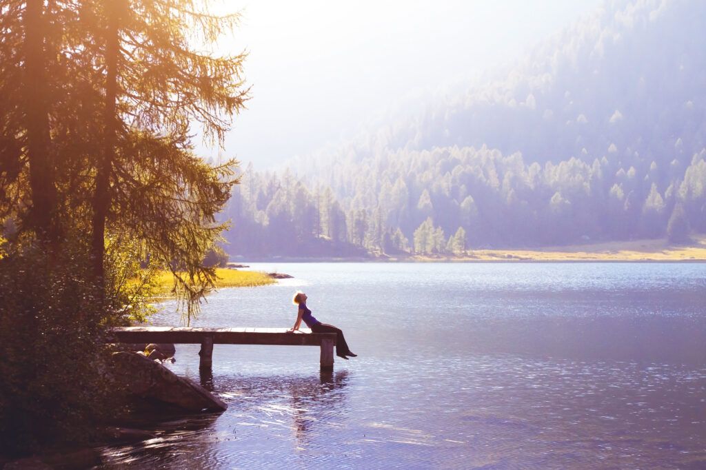 A person sitting on a dock looking for the key to a happy life