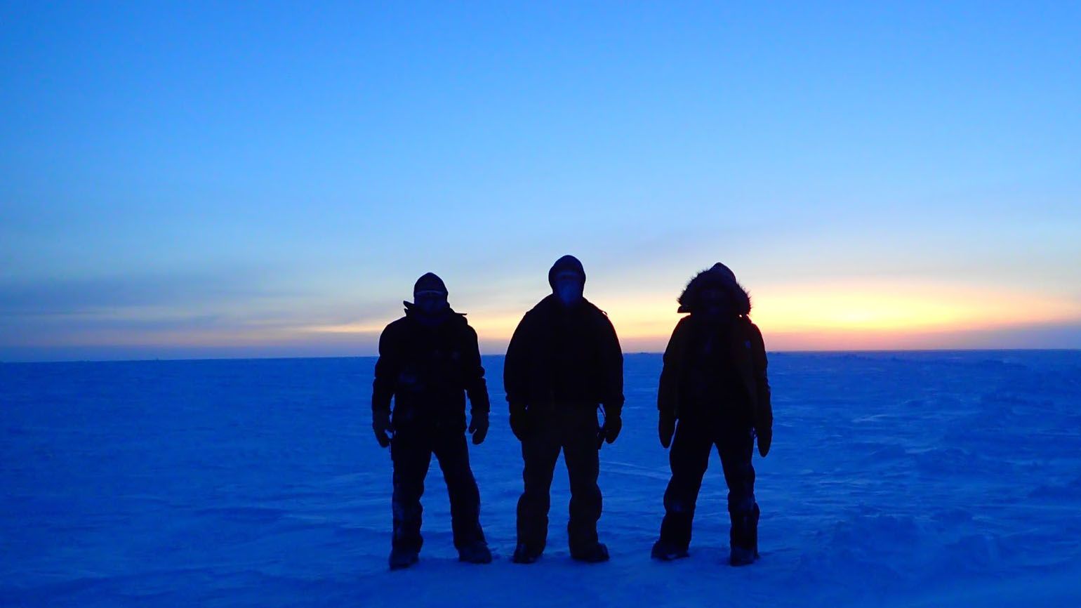 Silhouettes of Brett and his team in the South Pole.
