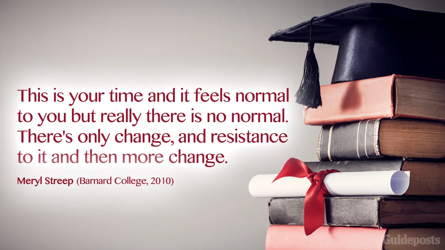 A stack of various textbooks with a diploma resting on one of them and a graduation cap on top.