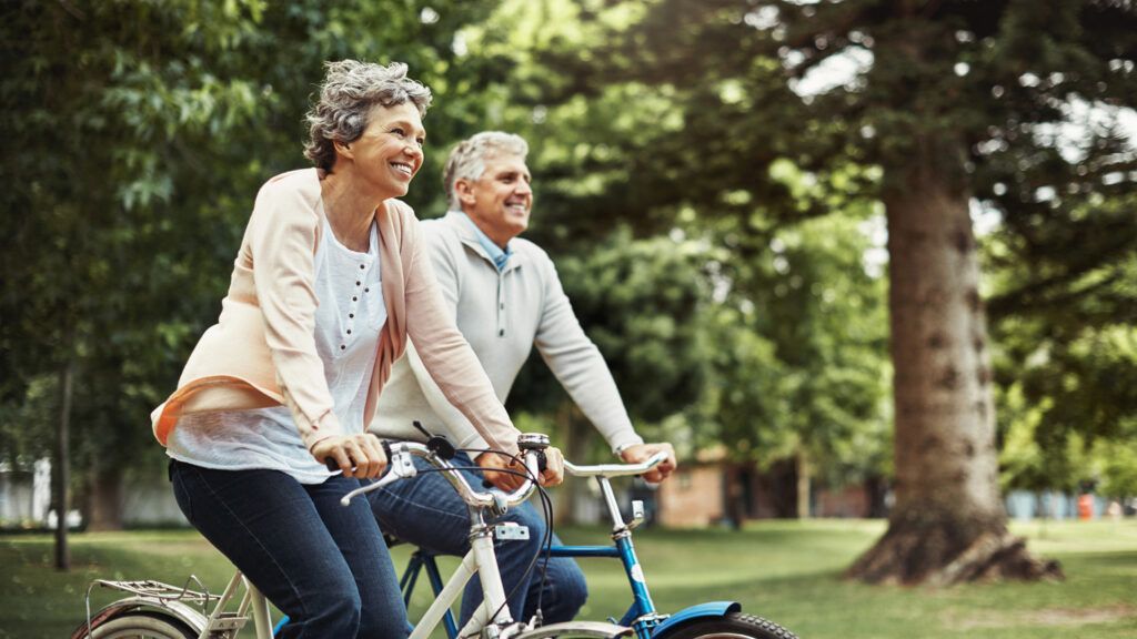 Shot of a mature couple enjoying a bike ride in the park.