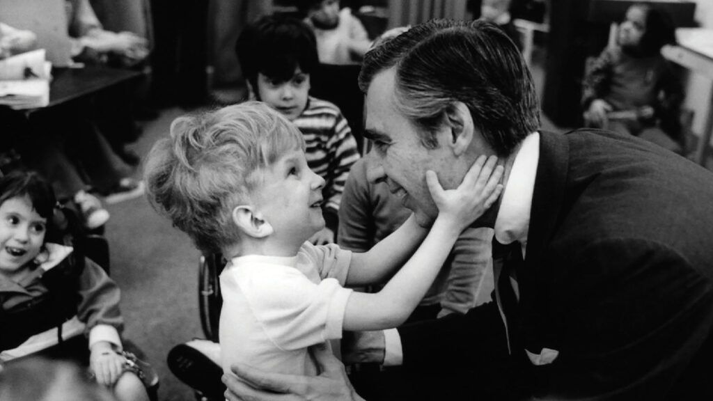 Fred Rogers with a disabled boy on his TV series.