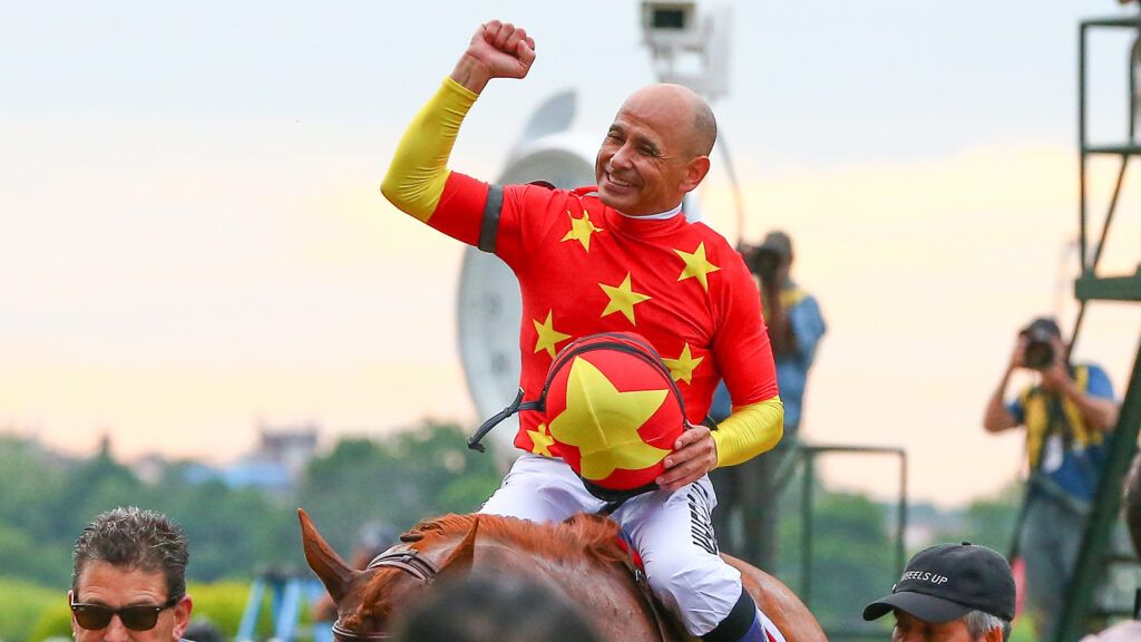 Mike Smith celebrates following his historic Triple Crown win