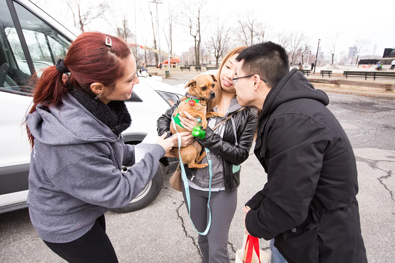 A Friends with Four Paws volunteer introduces a couple to their new furry pal.