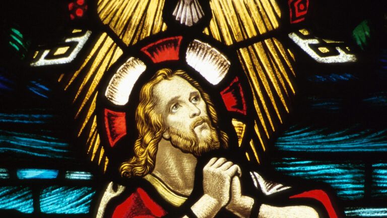 Stained glass image of Jesus praying for Bible verses for fasting