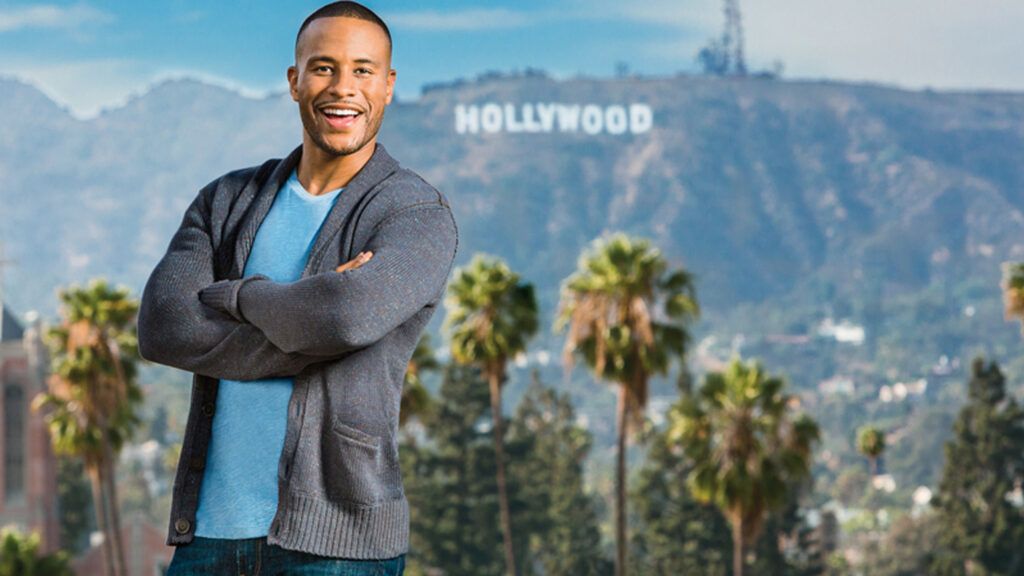 DeVon Franklin poses with the landmark Hollywood sign behind him.