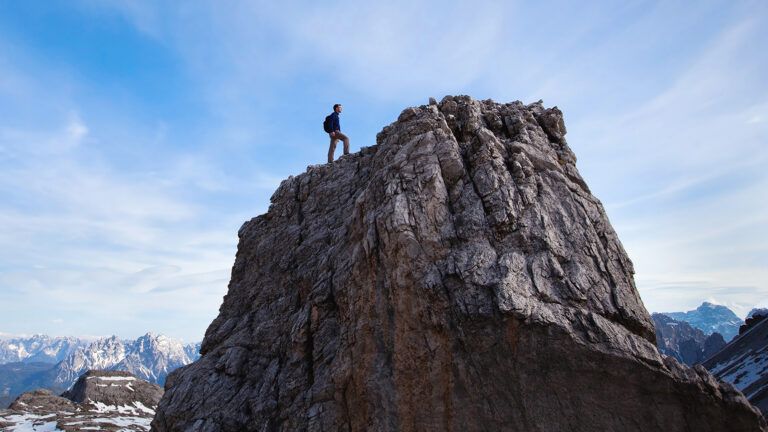 A man climbs a steep cliff