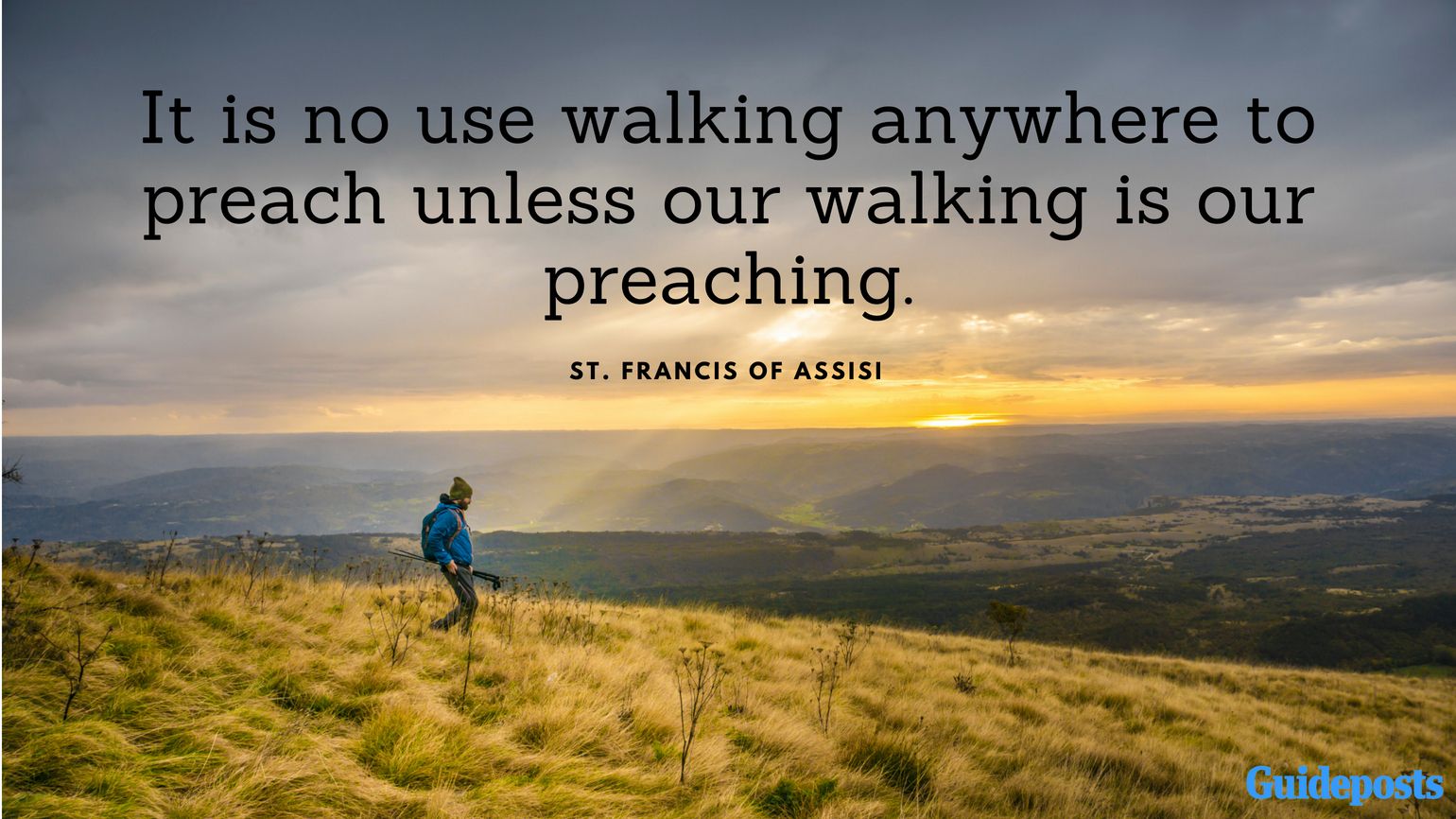 A person walking through a field with Saint Francis quotes