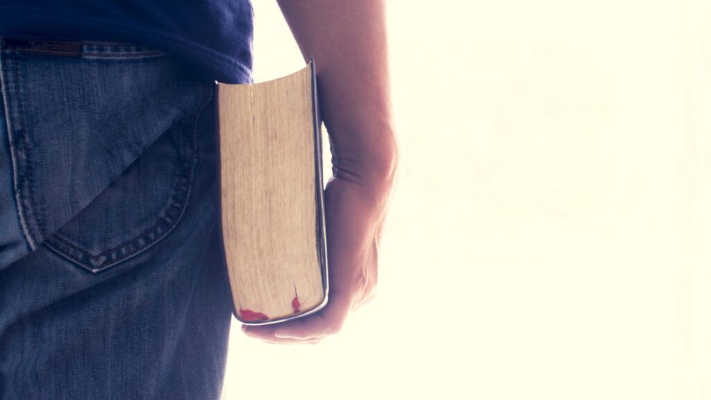 A man holding a Bible in his hand.