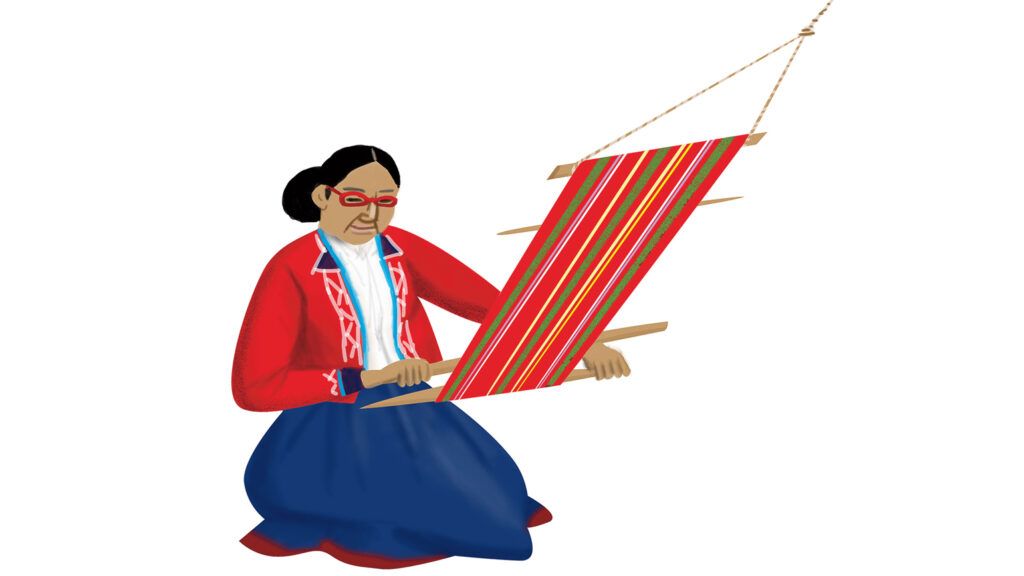 A Peruvian woman wearing glasses weaving with colorful yarn.