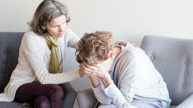 A woman helps her friend in distress.