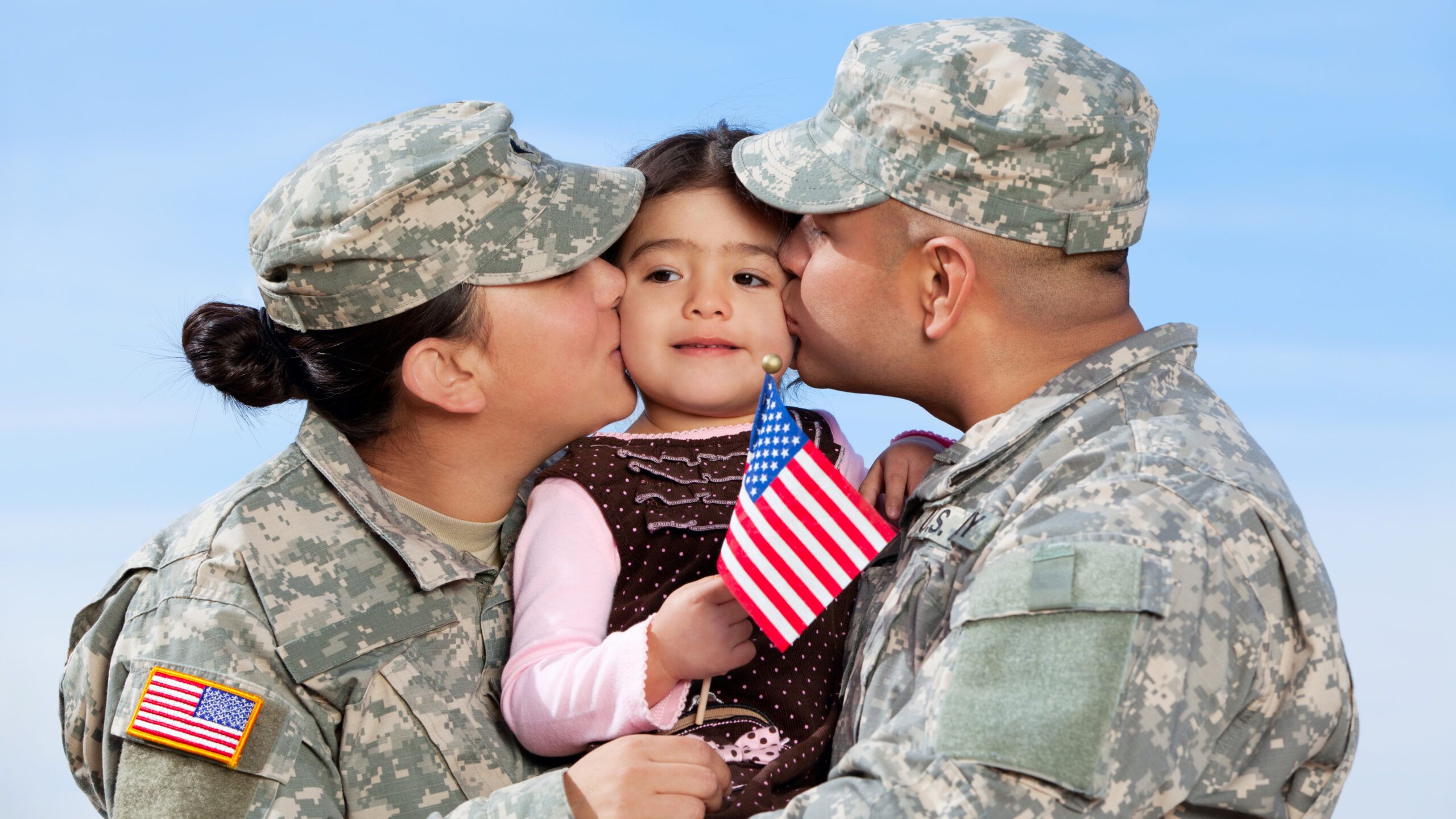 Military couple hugging child