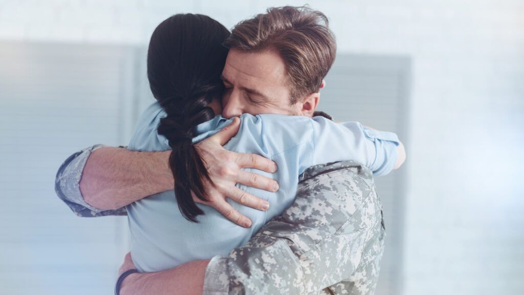 Military couple embracing