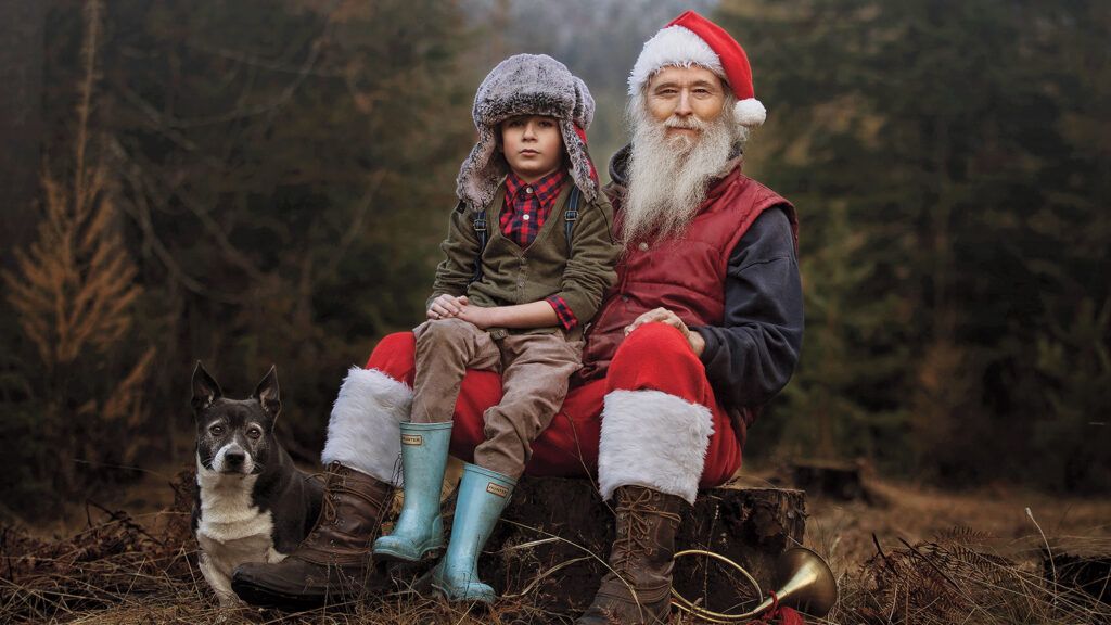 Robin's son Ryder poses with Santa Claus and his dog at the Christmas-tree farm