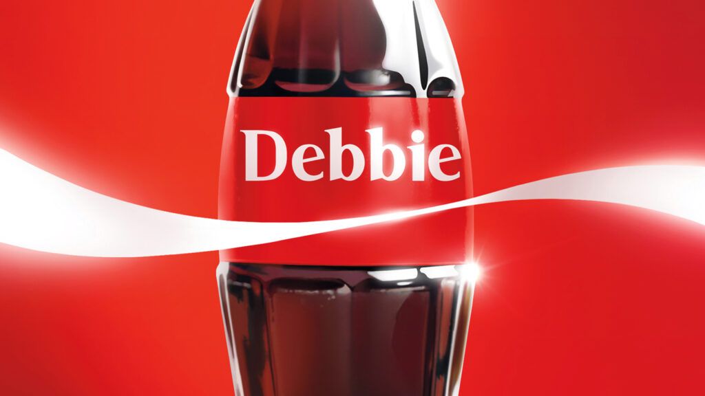 A vintage glass Coke bottle with 'Debbie' on the label.