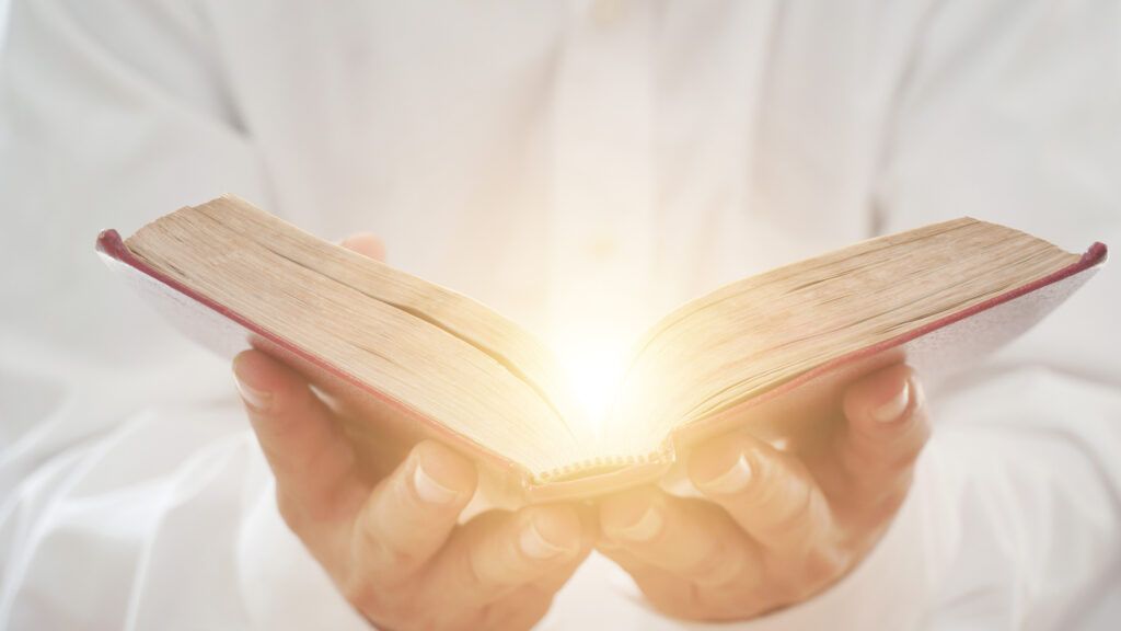 Man holding an open Bible
