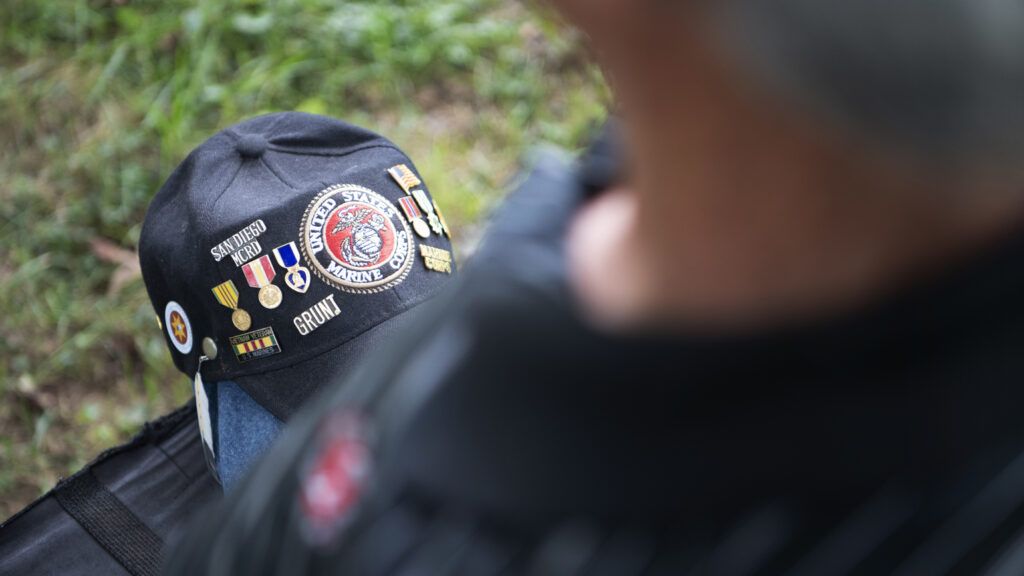 Eddie's cap, which memorializes his time in Vietnam, rests in his lap.