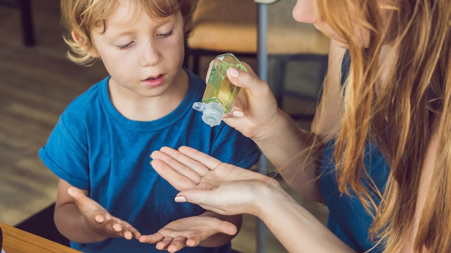 Health myths about Winter: Using Hand Sanitizer will keep you virus-free. Mother squeezing hand sanitizer on son's hands. better living health wellness