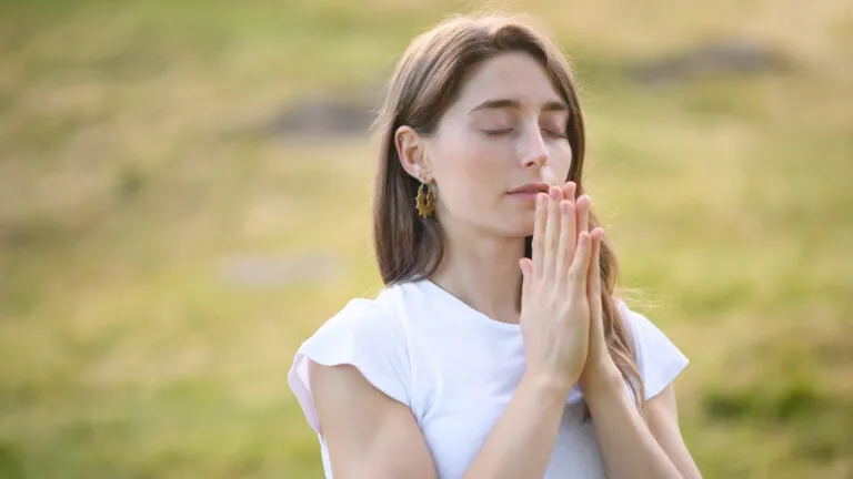 Woman outside saying lenten prayers