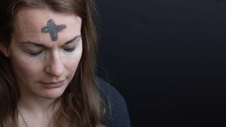Woman with an ash cross on her forehead for her ash wednesday reflection