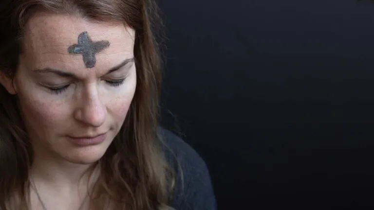 Woman with an ash cross on her forehead for her ash wednesday reflection