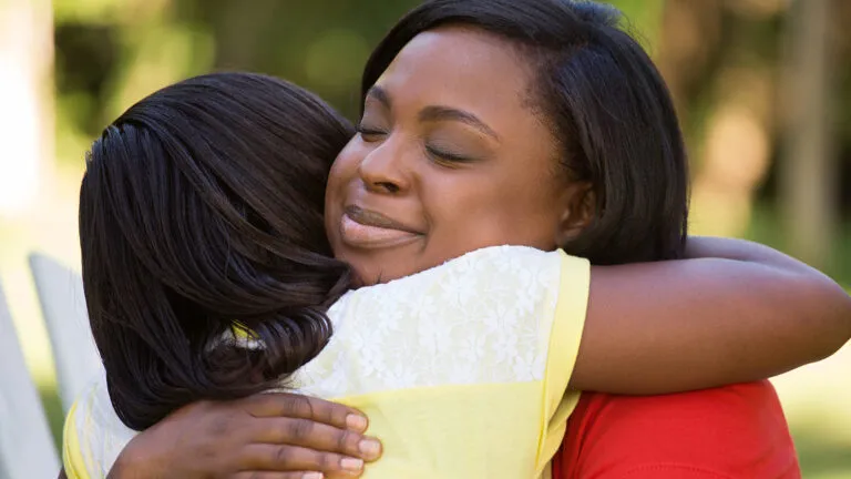 A forgiving mother hugs her daughter