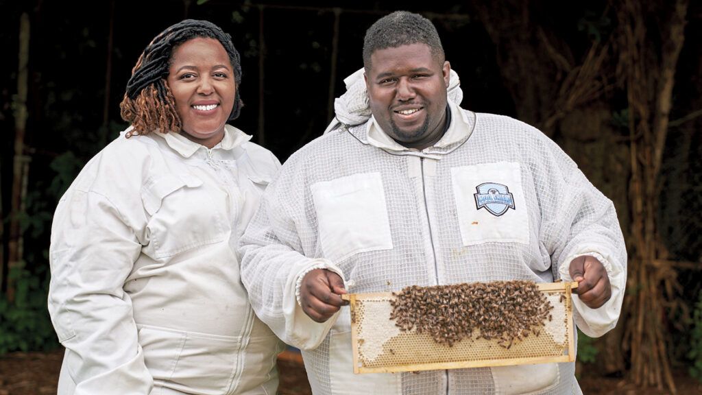 Beekeepers Timothy Paule and Nicole Lindsey