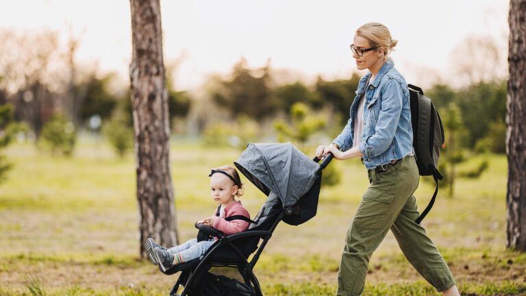 A young mom says her spring prayers while she pushes her daughter in a stroller