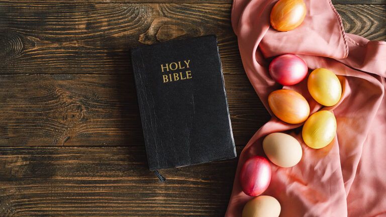 Holy bible on a table with easter eggs and quotes