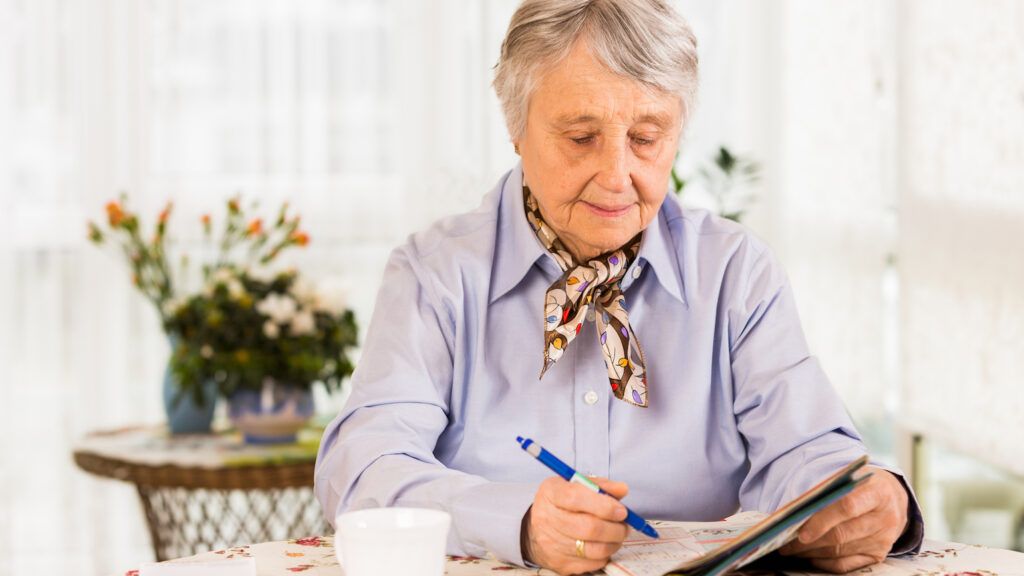 Senior woman doing a crossword puzzle