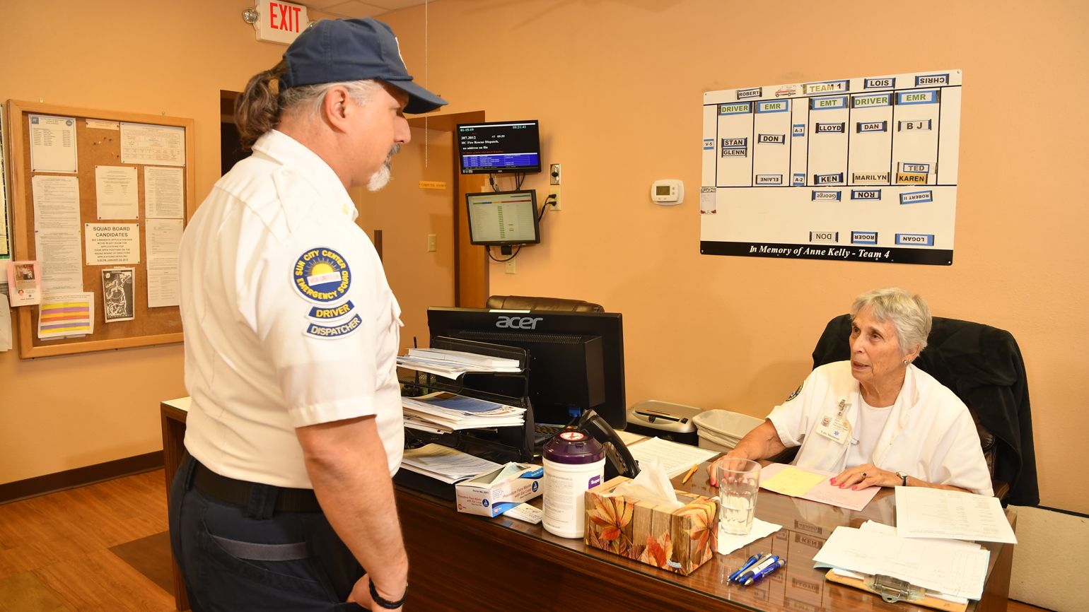 Captain Robert Leonard talking to Coordinator Louis Shannon. She keeps track of the ambulances.