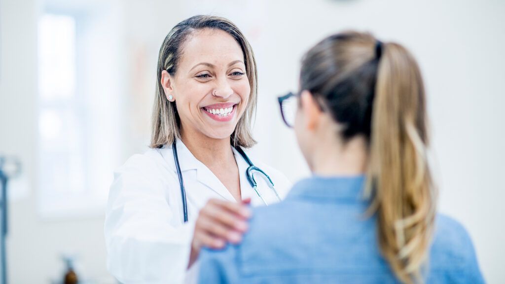 A positive doctor meets with a patient