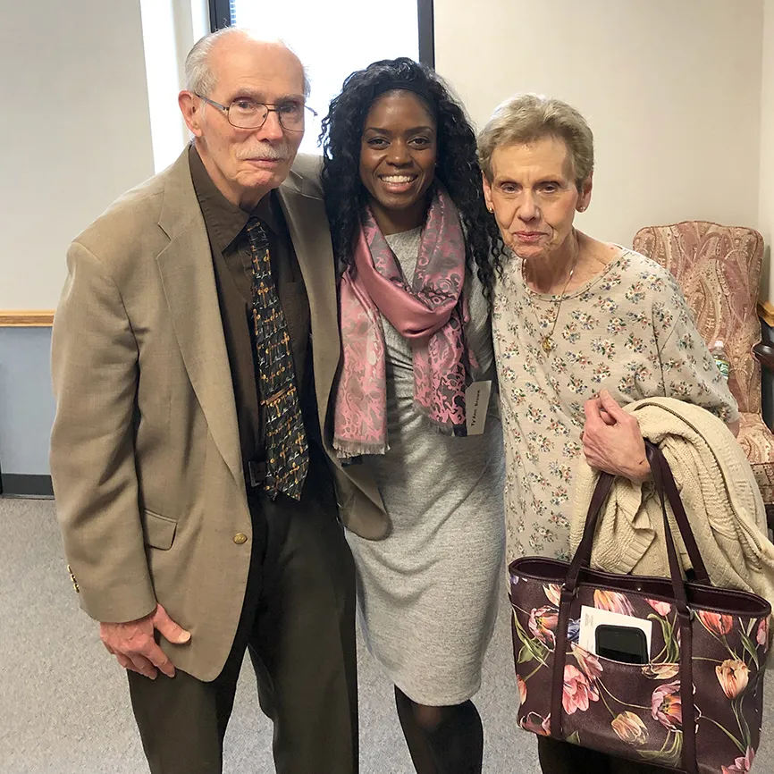 Guideposts staffer Ty'Ann Brown (center) greets a pair of attendees for Good Friday Day of Prayer.