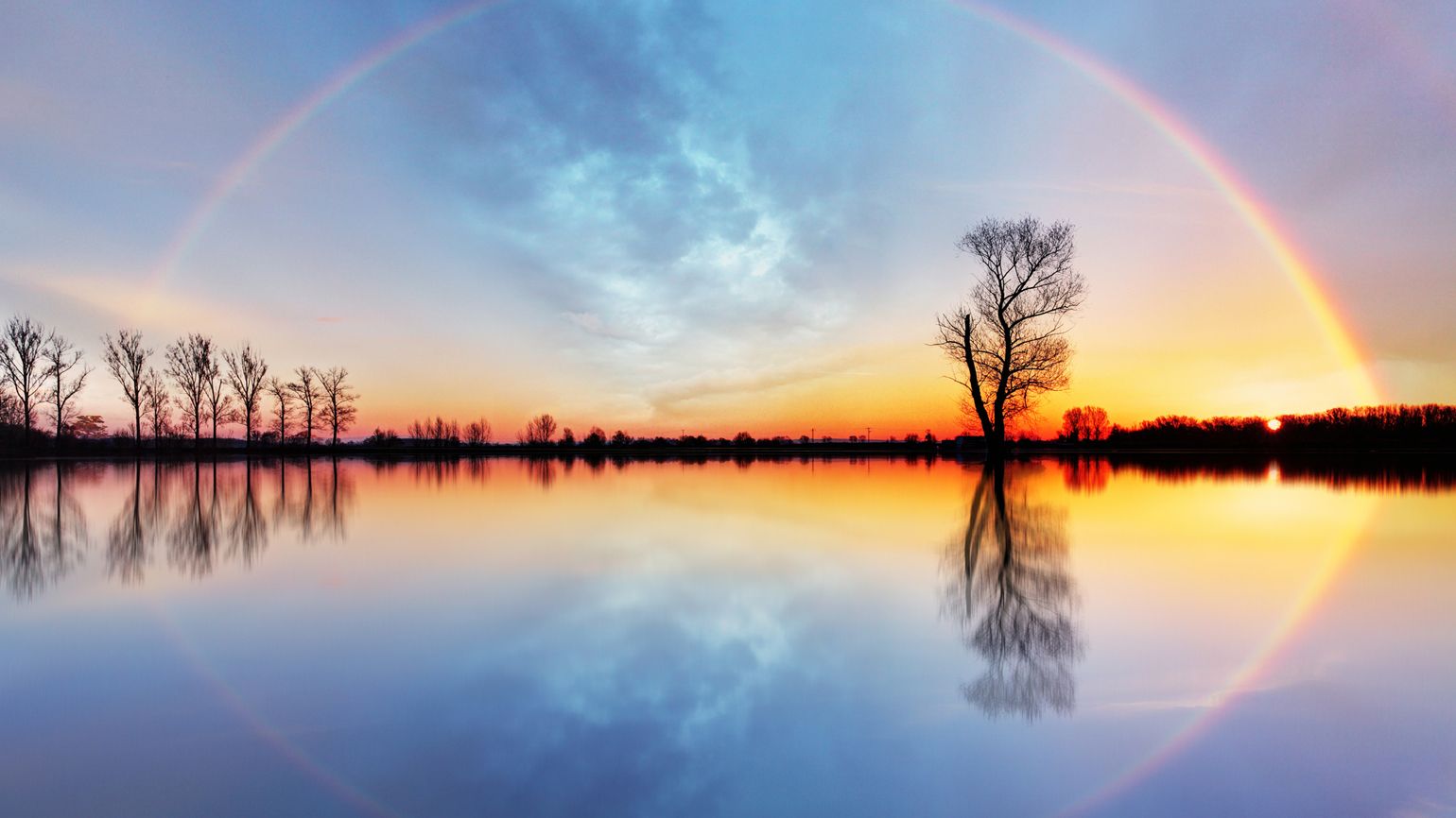 A rainbow against a brilliant sunset.