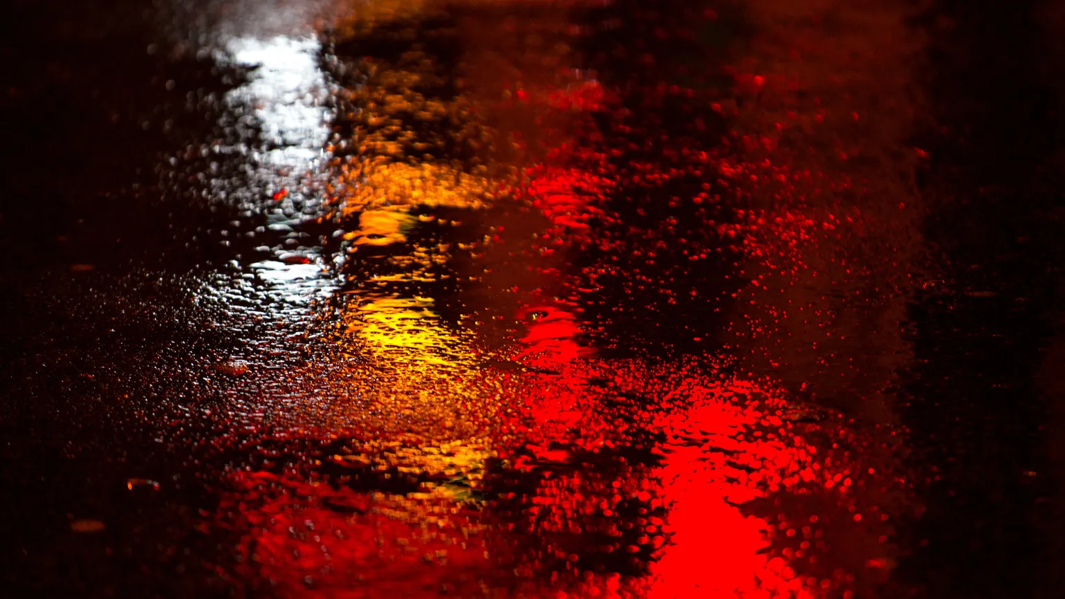 A puddle of water with changing colors.