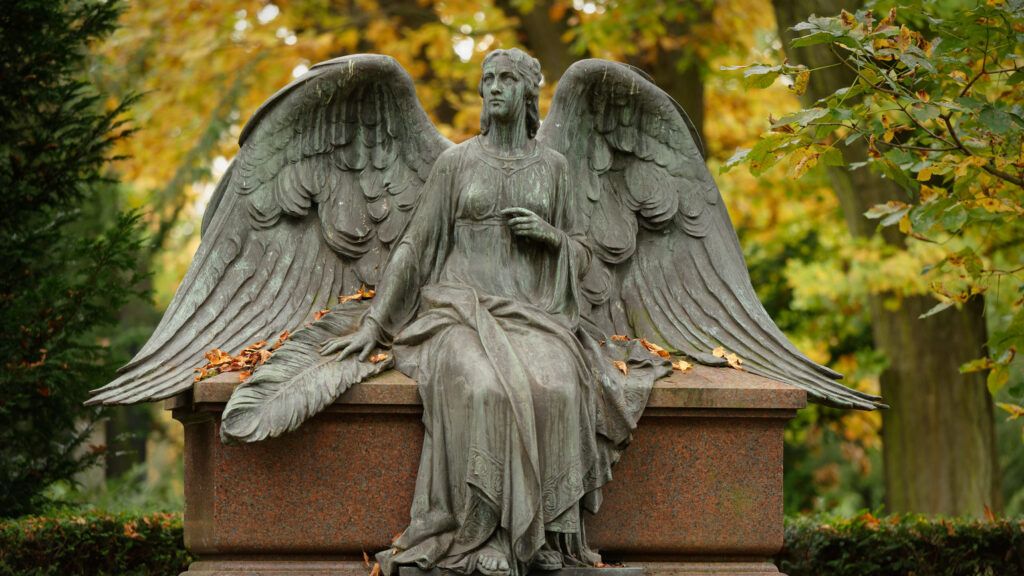 Actual angel statue in a cemetery in autumn