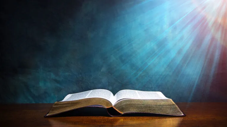 An open Bible rests on a table