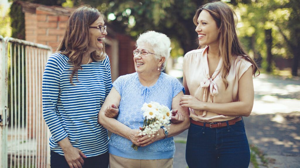 A caregiver and her mother meet a friend in their community.