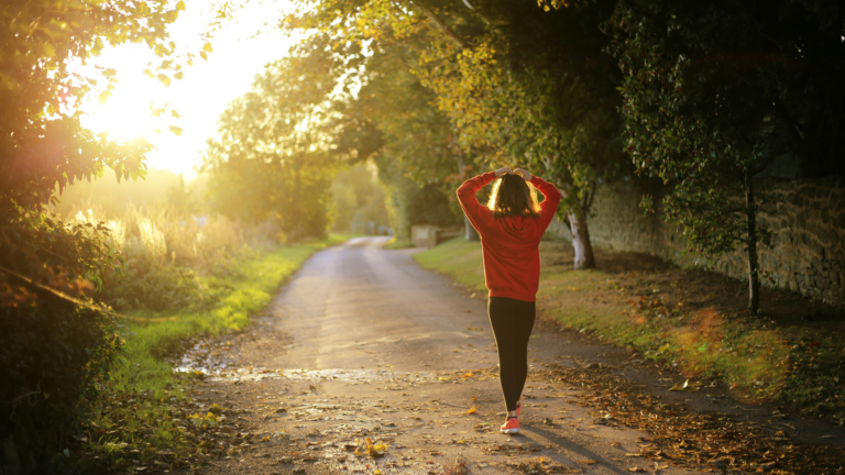 Woman walking on a pathway during the day.