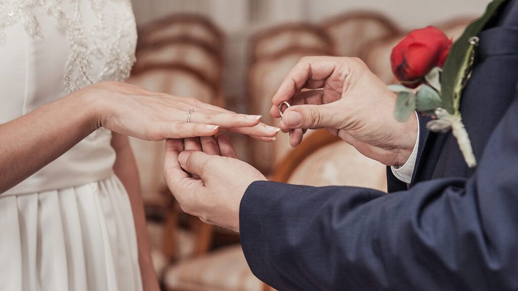 A mature couple exchanges rings during their wedding ceremony