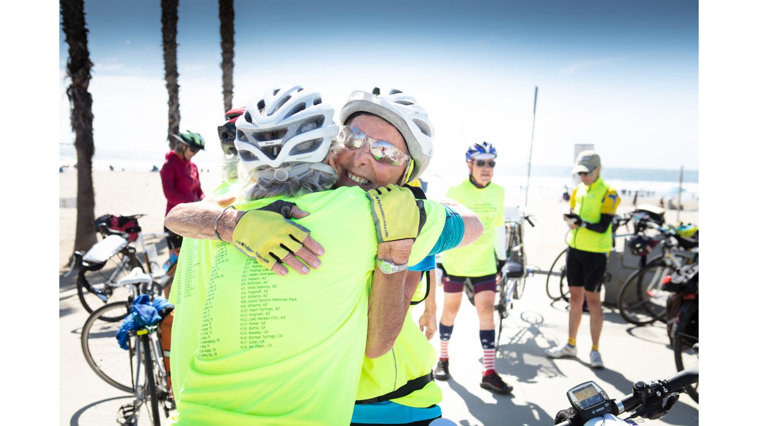 Carol Garsee, Cancer Survivor, Hugging her team member after completing cross country biking tripi in San Diego.  better living health wellness living longer living better