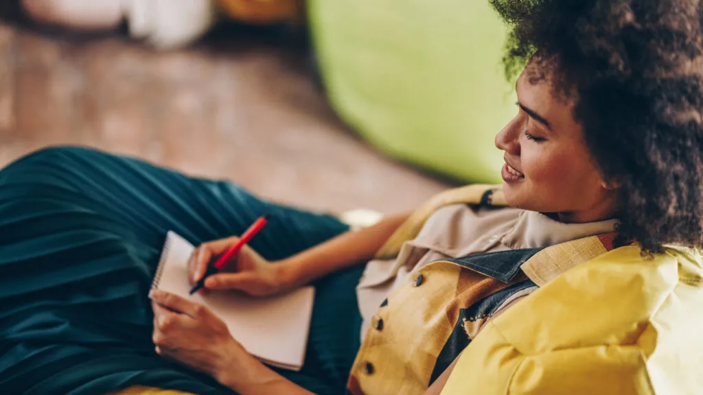 A woman writing in her daily journal.