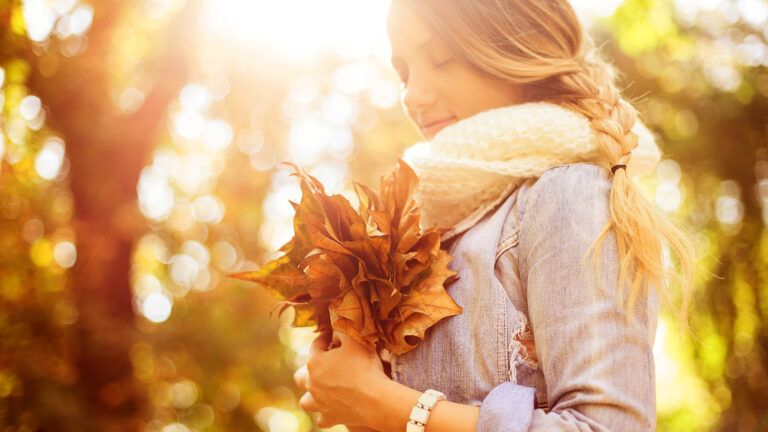 A young woman counts her blessings during a walk on an autumn afternoon